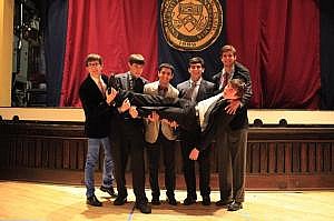 The business staff holding up Chairman Noah Goldstein.